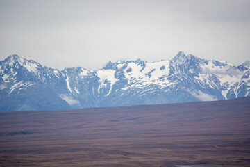 Snow-Capped Mountains Under Cloudy Sky