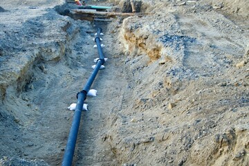 pipe in a trench with sandbags