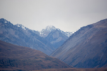 Majestic Snow-Capped Mountains Under Cloudy Sky