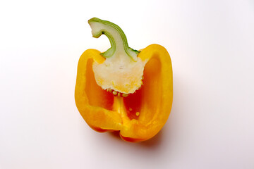 Fresh yellow bell pepper cut in half on white background