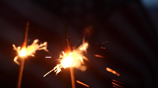 Happy 4th of July, Independence Day, sparklers, Fireworks Celebration. USA American flag waving sunset outdoor dark background. Concept fourth of July, 4th of July, USA, Freedom, Independence Day