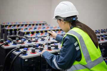 Technician inspects backup battery system carefully to ensure power supply is stable and reliable...