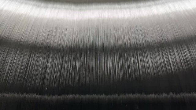 The unwinding of the threads from the bobbin of the warp of the knitting machine