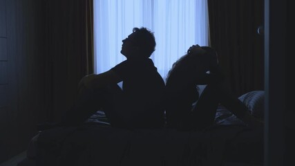 couple quarreling concept of family relationship problems divorce, black silhouette of man and woman sitting at bed back to back resentment towards each other window in dark room. guy cheated on girl - Powered by Adobe