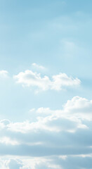 Obraz premium A serene view of a bright blue sky dotted with fluffy white clouds, creating a peaceful and airy atmosphere.