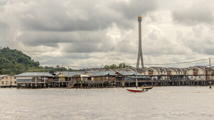 Motor boats and Kampong Ayer the floating village wooden Malay traditional houses standing on stilts on the river, Bandar Seri Begawan, Borneo, Sultanate Brunei Darussalam