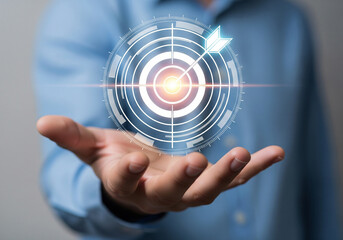 Fototapeta premium Hand Presenting a Digital Target with an Arrow Hitting the Bullseye, Symbolizing Business Goals and Achievement on a Blurred Background