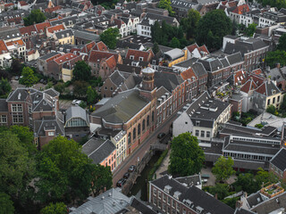 Aerial view of Utrecht, Netherlands, featuring a historic brick building with a tower, a canal,...
