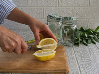 A woman with a lemon cut lengthwise.