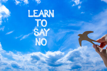 Learn to say no symbol. Concept words phrase Learn to say no on beautiful blue sky. Businessman's...