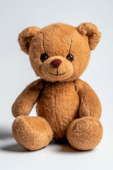 Obraz premium Soft plush teddy bear with brown fur sitting upright, isolated on white background. 