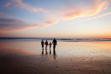 Portrait silhouettes of three children and dad happy kids with father on beach at sunset. happy...