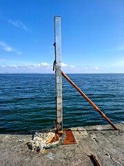 pier in the sea.
view of wooden beam multifunctional value installed on pier on sea and sky...