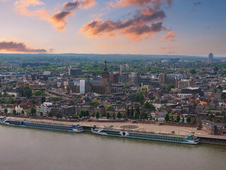 Aerial view of Nijmegen, Netherlands, featuring the Waal River, docked cruise ships, St....