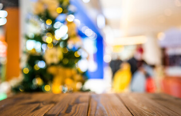 Wooden table in front of a blurry Christmas tree