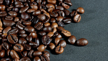 close up of many coffee beans on black background