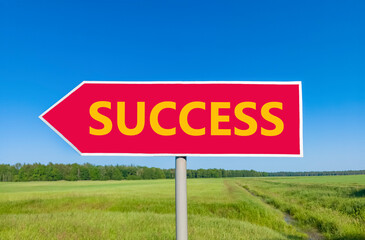 Success symbol. Concept word Success on beautiful red road sign. Beautiful blue sky green grass and forest peaceful nature background. Business success concept. Copy space.