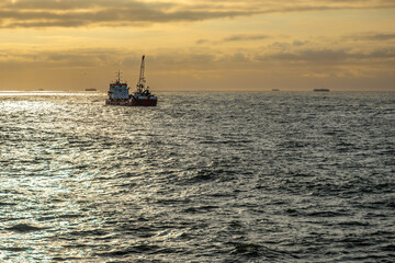 A dredger working at the entrance to the port of Mar del Plata at dawn