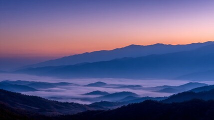Obraz premium Purple And Blue Sunrise Over Foggy Mountain Valley