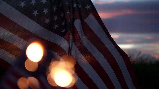 Happy 4th of July, sparklers, Fireworks Celebration. Defocus sparkler firework, USA American Flag waving sunset outdoor dark background. Concept fourth of July, USA, Freedom, Independence Day