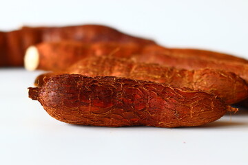 Tapioca also known as cassava roots or yuca or manioc, on a clean white background