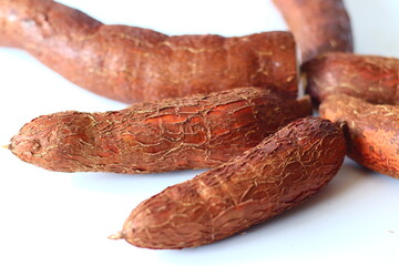 Tapioca also known as cassava roots or yuca or manioc, on a clean white background