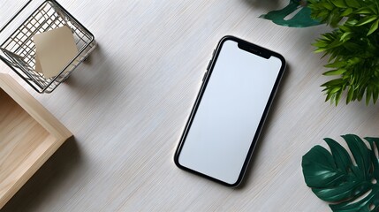 a smartphone with a protective case is placed on a surface next to a white plant, against a background that includes a wooden tabl