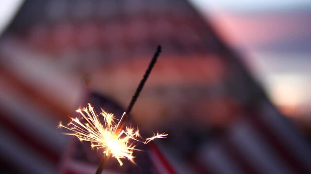 Happy 4th of July, Independence Day, sparklers, Fireworks Celebration. USA American flag waving sunset outdoor dark background. Concept fourth of July, 4th of July, USA, Freedom, Independence Day