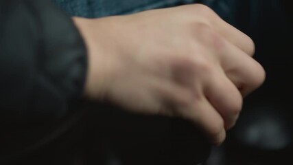Close up of car enthusiast shifting gear lever forward with expert motion, wrist and knuckles guiding stick through precise control in cabin, emphasizing driver skill and tactile feel