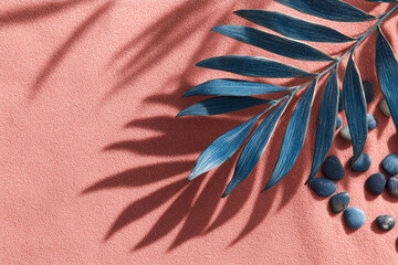 Serene Botanical Composition: A close-up shot reveals a vibrant display of a palm leaf and small rocks, casting intricate shadows against a soft backdrop. The scene exudes tranquility.