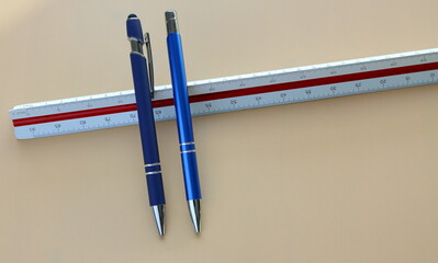 Two blue ink pencils and one 3D scale ruler.