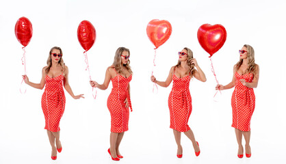 Woman in polka dot dress celebrates with red balloons while posing against a plain background for a...
