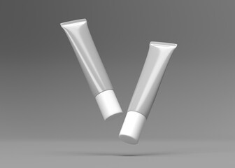 Two Blank White Tubes Falling Against a Gray Background - Mockup for Cosmetic or Pharmaceutical