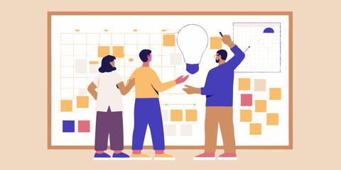 Diverse team collaborating on a project with a large lightbulb idea on a whiteboard