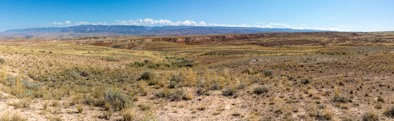 A scenic view from the Red Gulch/Alkali Backcountry Byway in Wyoming with mountains in the distance along the horizon. 