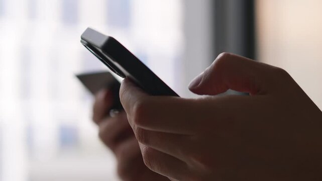 A man using a phone and a bank card uses the services of a bank and transfers money online.
Transfer money from a card.
Current account and online purchases