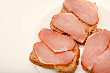 Ham sandwiches. Ham cut into thin slices.