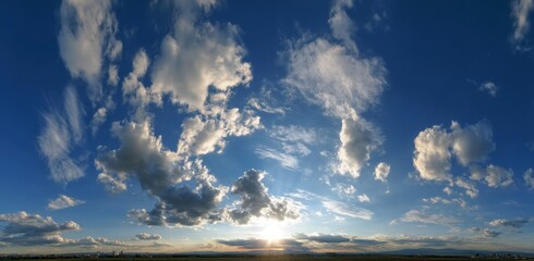 Wide Panoramic View of Sunset Sky with Fluffy White and Gray Clouds