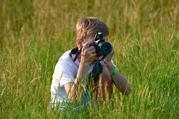 Boy, 10 Years Old, Sitting in Tavern and Photographing with Mirrorless Camera
