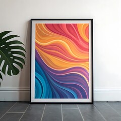 Colorful abstract wave art print in a black frame leans against a white wall with a monstera leaf nearby