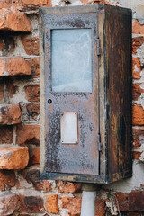 Rusted Industrial Electrical Box on Old Brick Wall