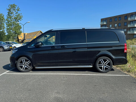 Almere, the Netherlands - June 29, 2025: Black Mercedes-Benz Vito Tourer extra long passenger van parked on a public parking lot. Nobody in the vehicle.