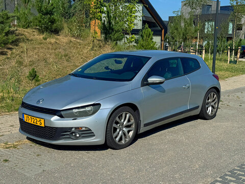 Almere, the Netherlands - June 29, 2025: Volkswagen Scirocco coupe parked on a public parking lot. Nobody in the vehicle.