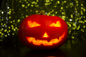 Creepy Jack-o'-lanterns glowing in the night. Pumpkin for Halloween. A gloomy, scary background for...