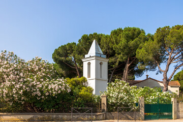 White chapel with oleander and pine trees, Corsica
