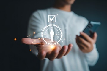 Man holding a smartphone in his hand with a digital human icon in a target scope and a checkmark above representing selection or achievement