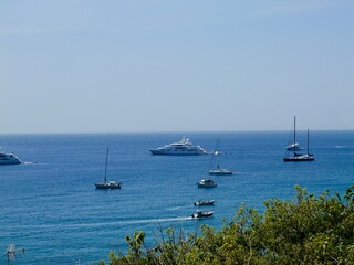 The yachts and boats is in the Ionian Sea, close to the town of Taormina on the east coast of...