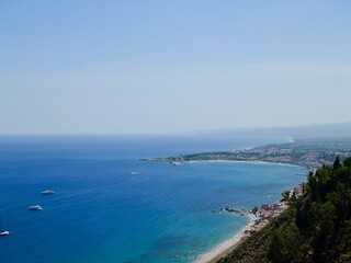 View of the Ionian Sea coast at Taormina town, Sicily, Mediterranean Sea coast. Italy