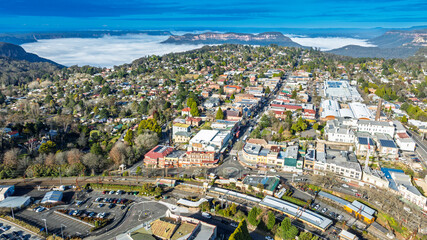 Drone aerial photograph of the picturesque and tourism town of Katoomba and the Jamison Valley full of low level clouds in the Blue Mountains, NSW, Australia.