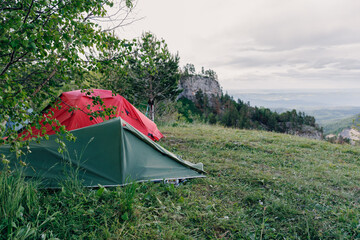 Camping with a tents in the mountains, hiking in summer